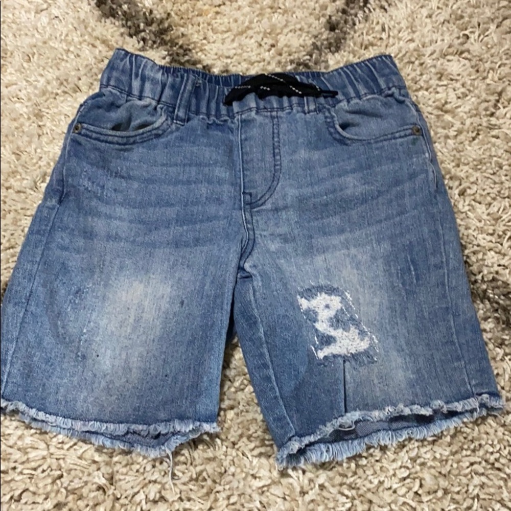 Boys cut off distressed shorts.